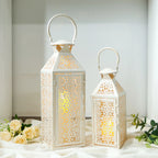 Two white lanterns with intricate cut-out designs on a light background.