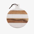 Round marble and wood striped serving board with a dark brown leather hanging loop, shown on a plain white background.