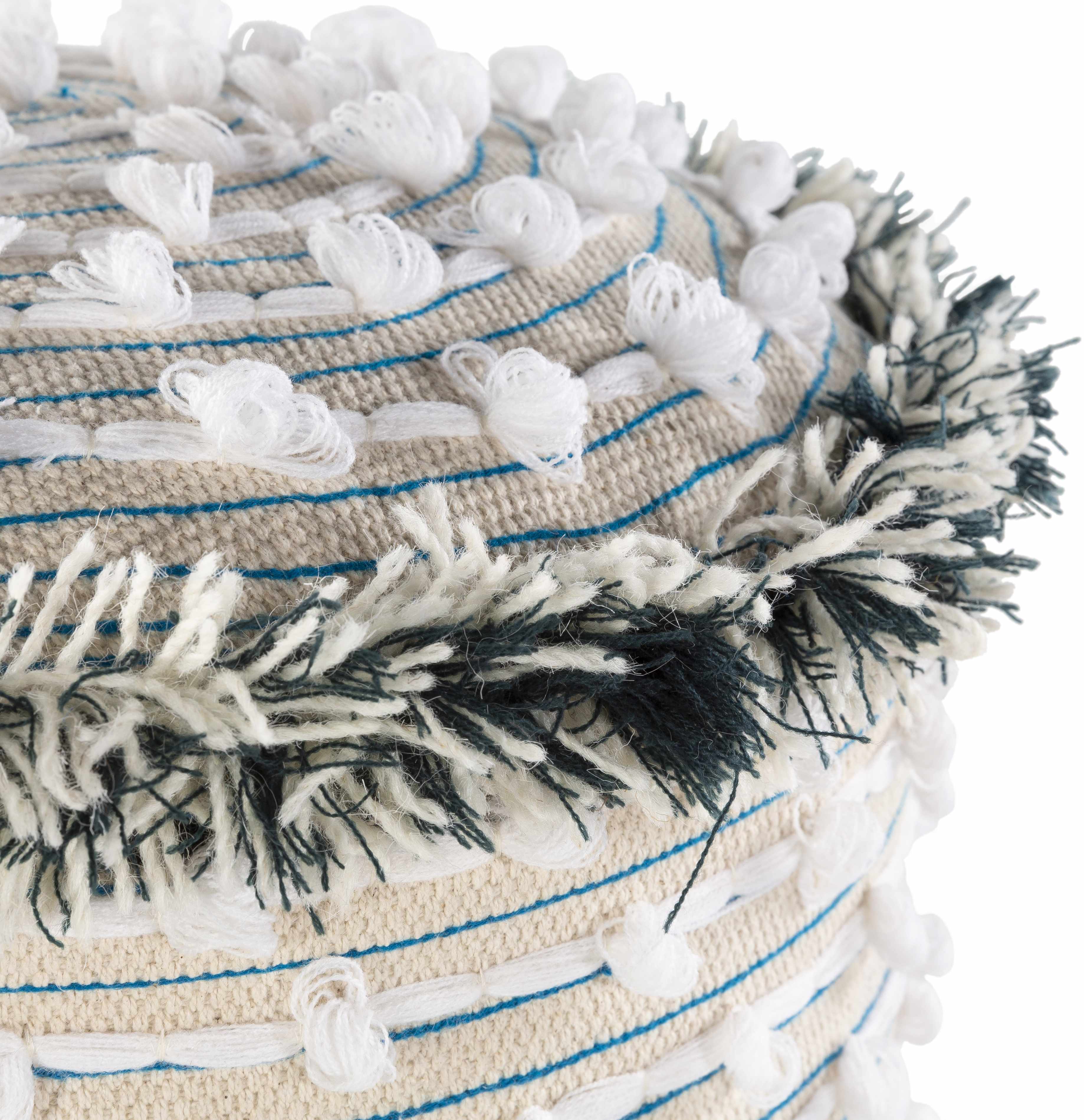 Close-up of a woven white and beige ottoman with tassels and decorative elements on a white background