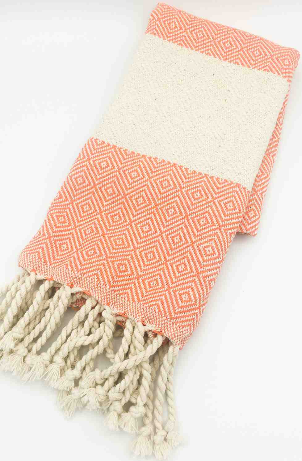 Orange diamond pattern hand towel with cream fringe tassels on white background