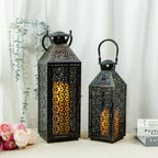Two ornate metal lanterns with intricate designs on a light background.