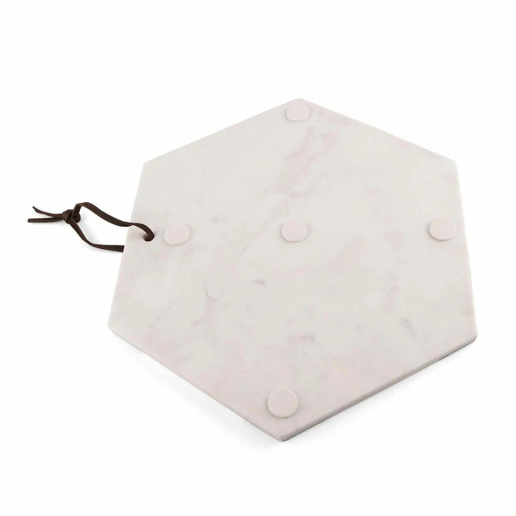 A hexagonal marble serving board with a dark brown hanging cord and four round suction cup feet on the underside, shown on a white background.