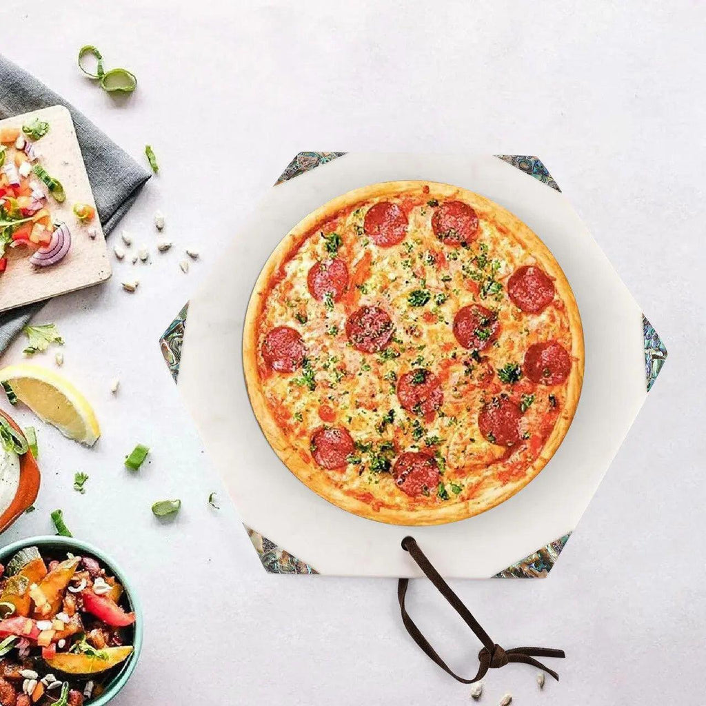 Pepperoni pizza on a white surface with side dishes