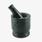 Dark green marble mortar and pestle set on a plain white background.
