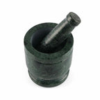 Green marble mortar and pestle on a white background
