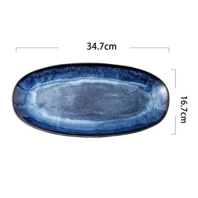 Eye of Ocean large ceramic plate — dimension diagram showing 34.7 cm × 16.7 cm, deep blue glaze
