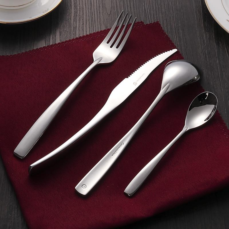 Silver cutlery set on a red napkin in the background.