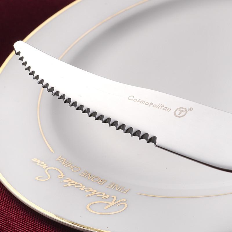 silver knife on a white plate with red napkin in the background