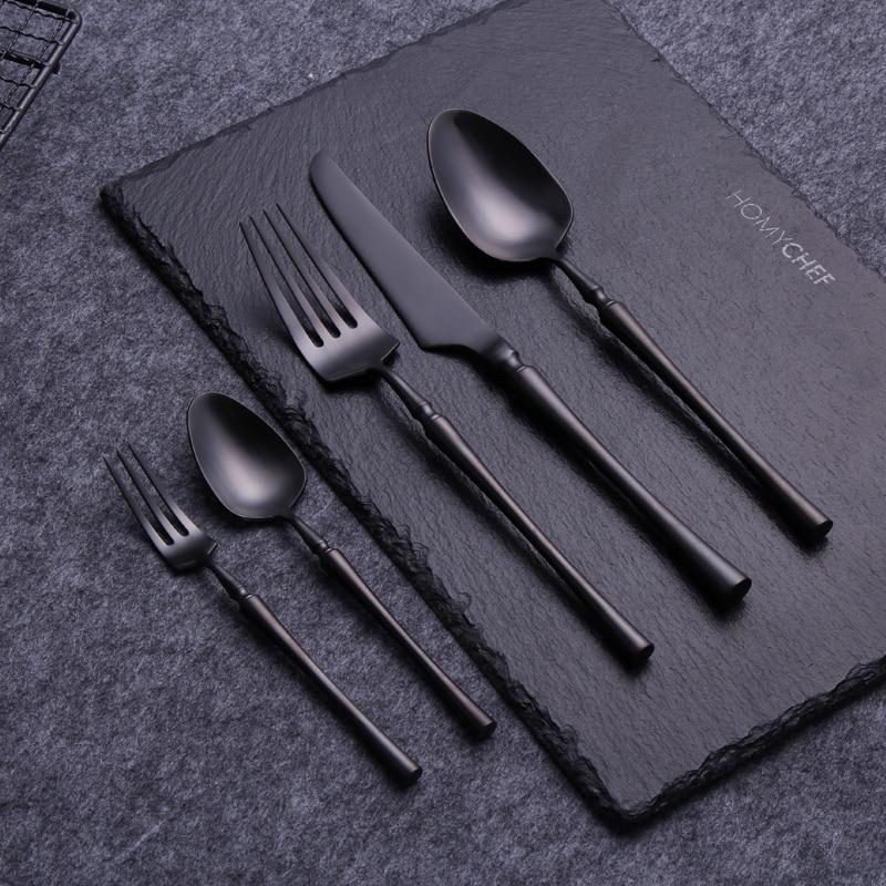 Set of black cutlery on a dark slate surface with 'HOWDYCHEF' branding.