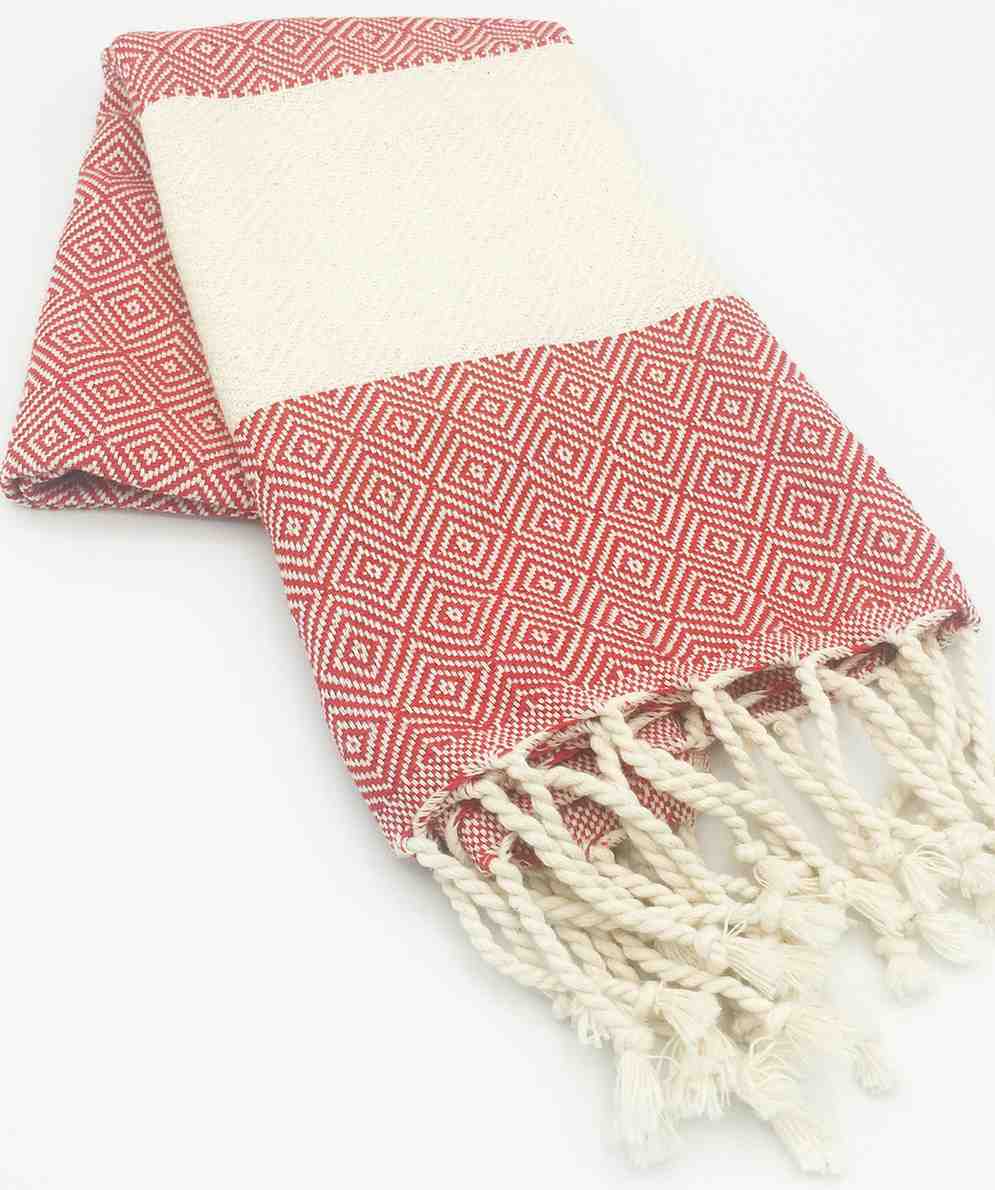 Red diamond-pattern hand towel with white fringes, displayed on a white background