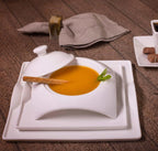 Modern white square dinnerware set with soup bowl and breadstick on rustic table