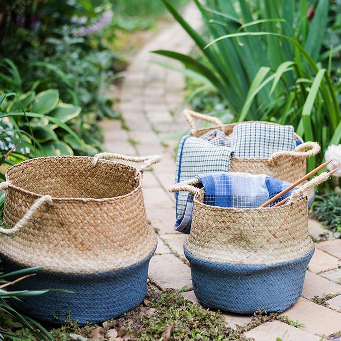 Woven baskets with blue accents on a garden path