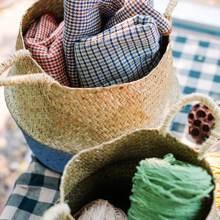 Woven basket with checkered fabric and yarn on a checkered surface