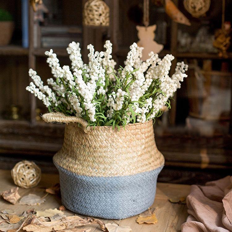 Woven basket with white flowers on a wooden surface