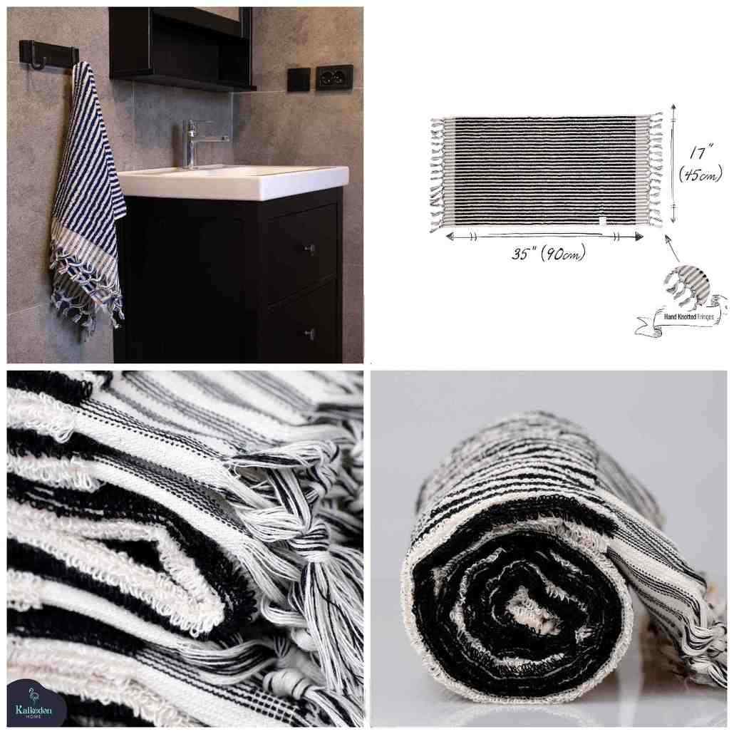 Black and white striped cotton hand towel with fringed edges, hanging and rolled