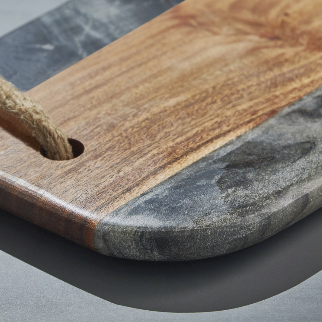 Wooden cutting board with stone finish on a gray surface