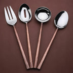 Set of four rose gold cutlery items including a fork and three ladle spoons on a brown background.