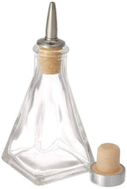 Clear glass bottle with wooden cap and metal nozzle on a white background