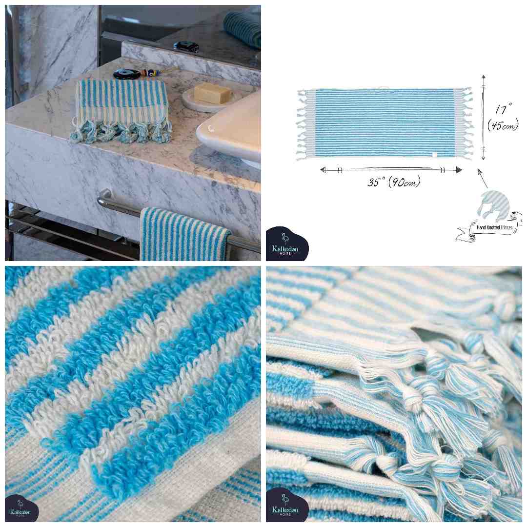 Turquoise striped cotton bath mat with knotted fringe in a modern bathroom setting