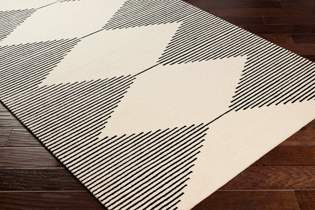 Geometric patterned rug with black lines on a wooden floor