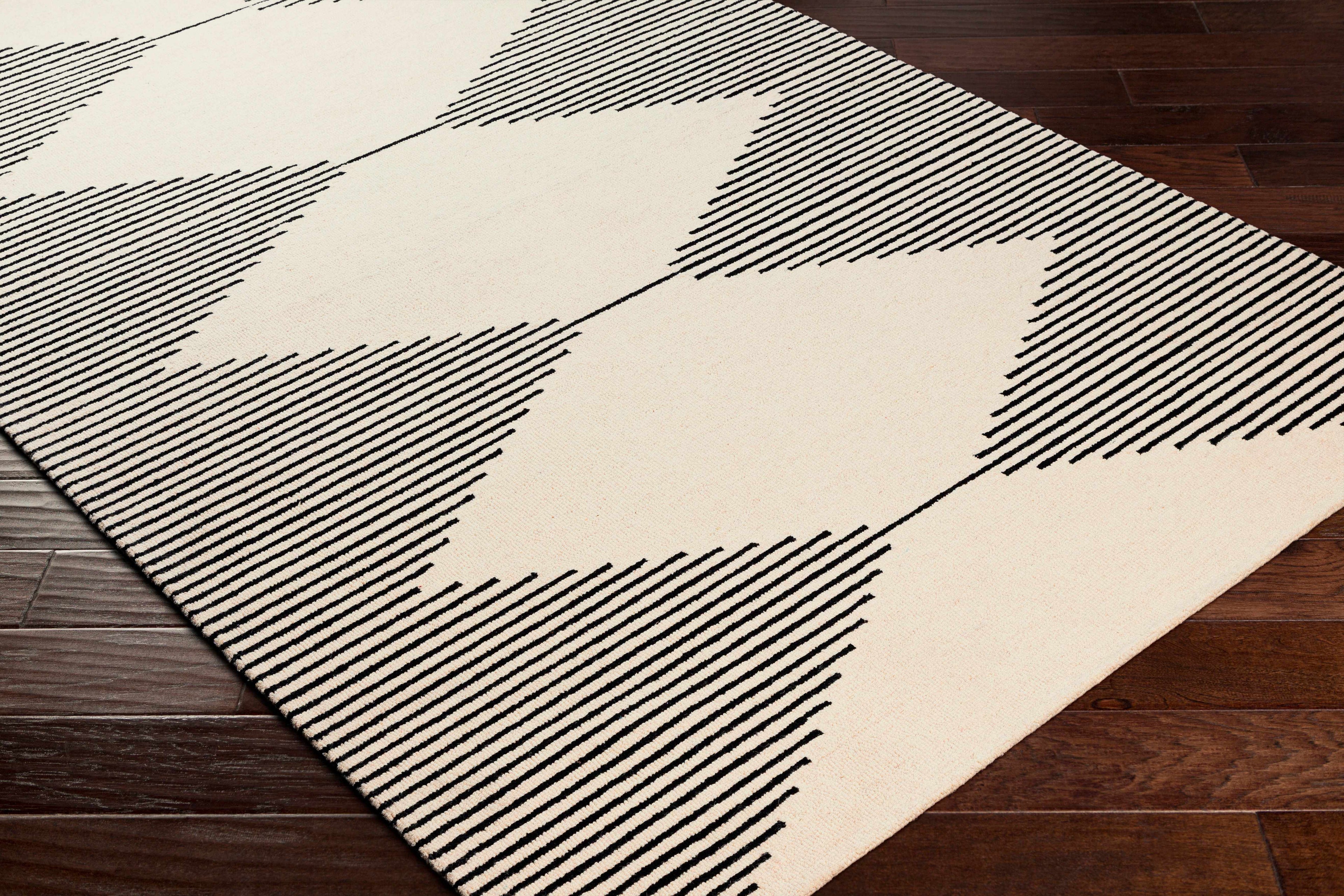 Geometric patterned rug with black lines on a wooden floor