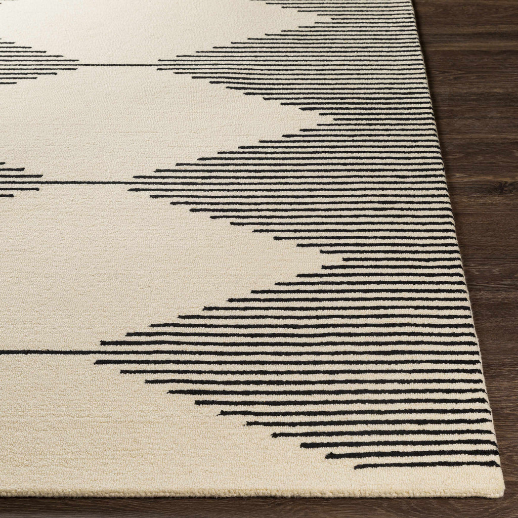 Close-up of a rug with black geometric patterns on a beige background