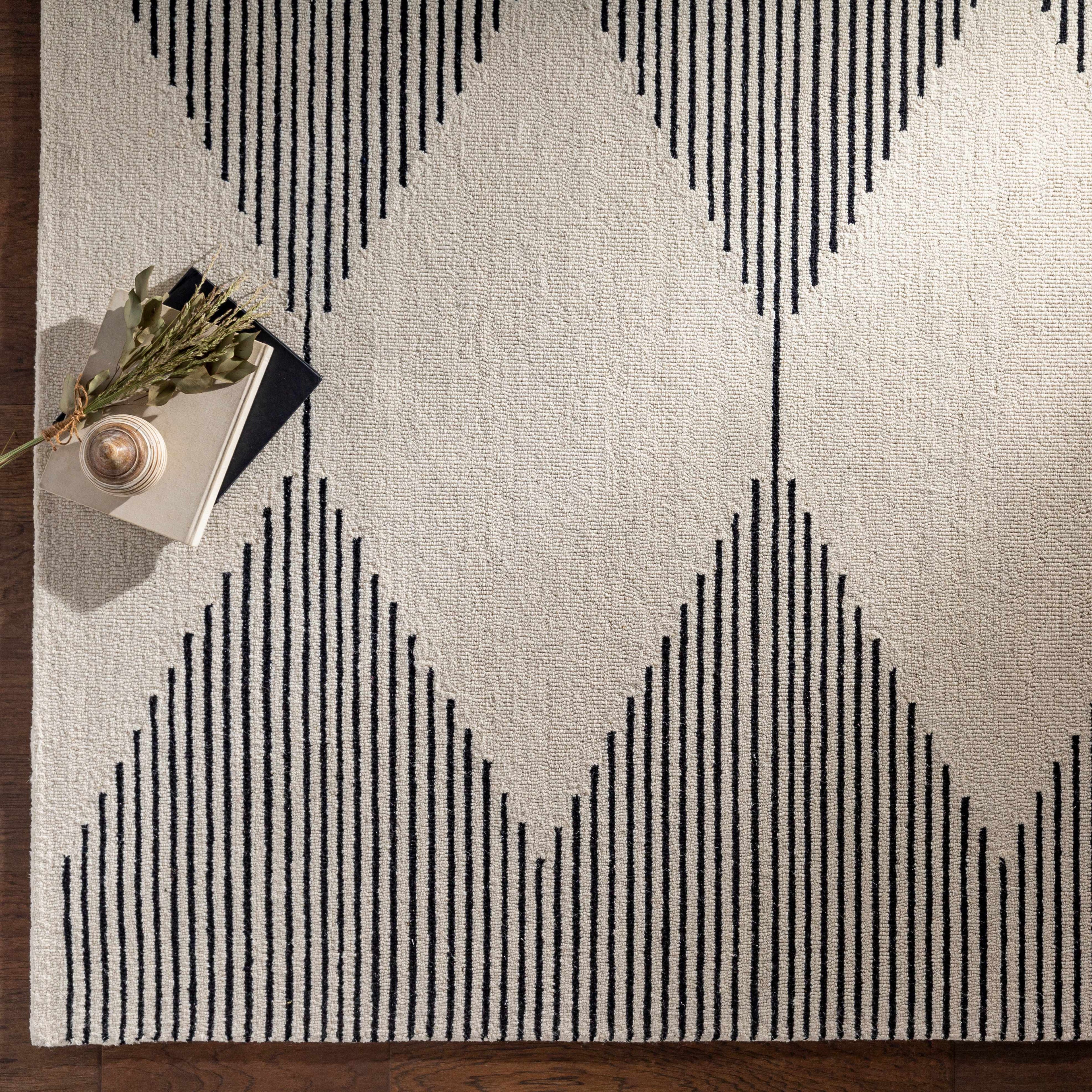 Geometric patterned rug with black lines on a neutral background