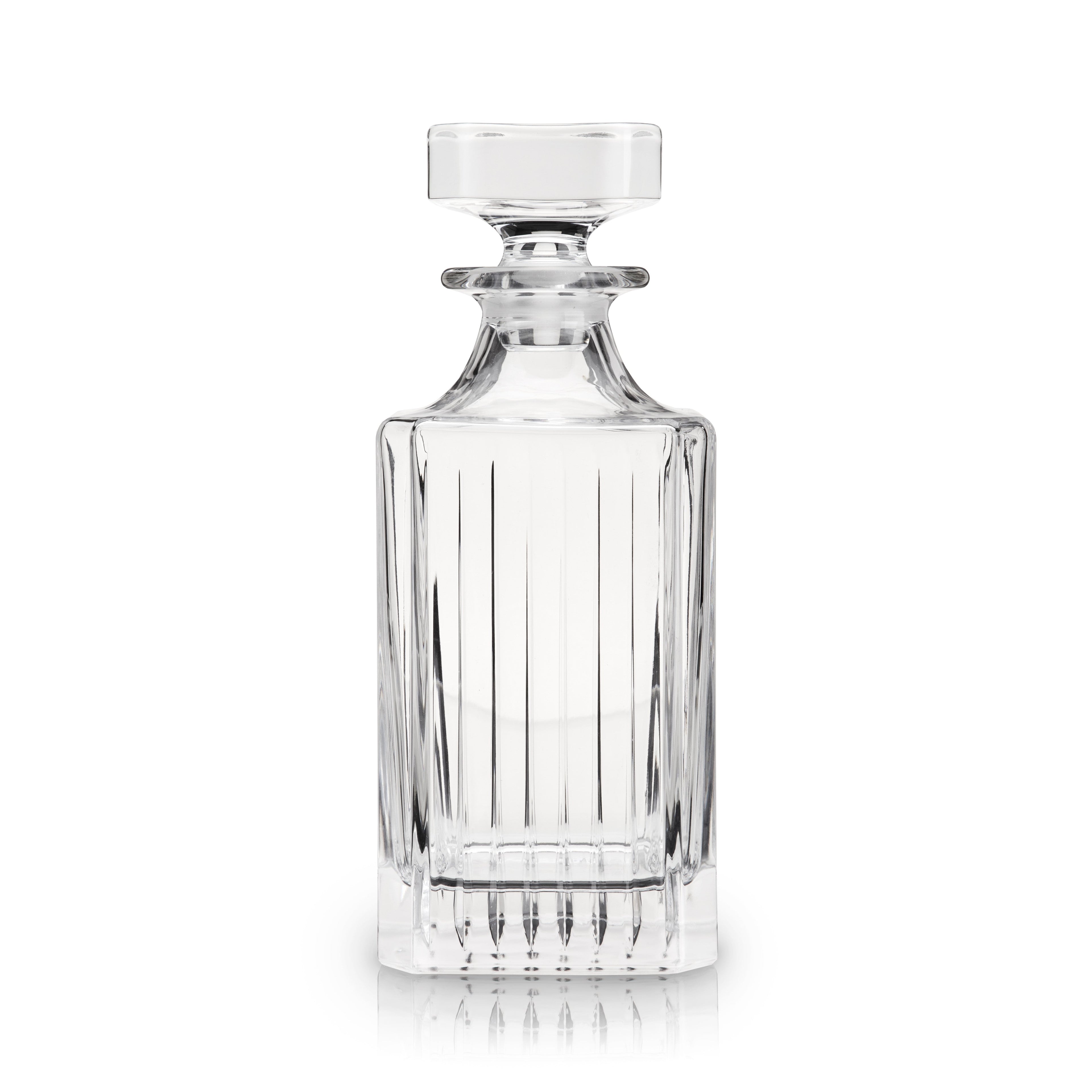 Clear glass decanter with a lid on a white background